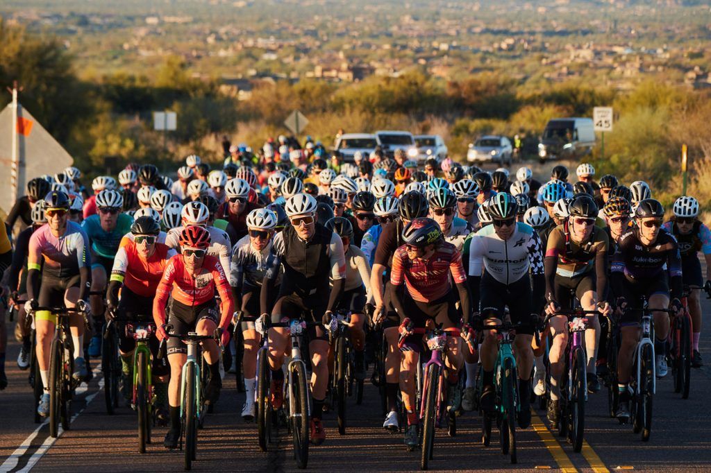 Hundreds of cyclists at the start line of an Arizona cycling race, held in a dessert.