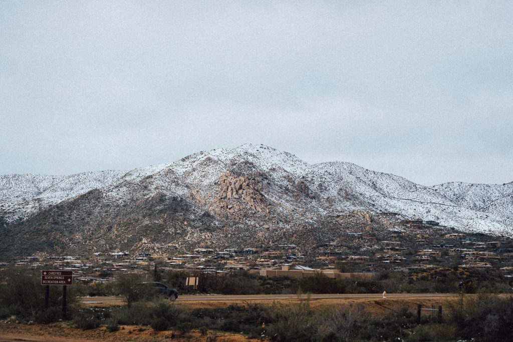 Arizona Desert with a snowy mountain in the background and shrubs in the foreground